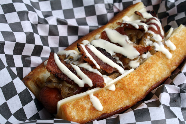 Photo of a Dog Haus dog (with aioli). From A Moveable Feast, whose author is far too forgiving of this abomination.